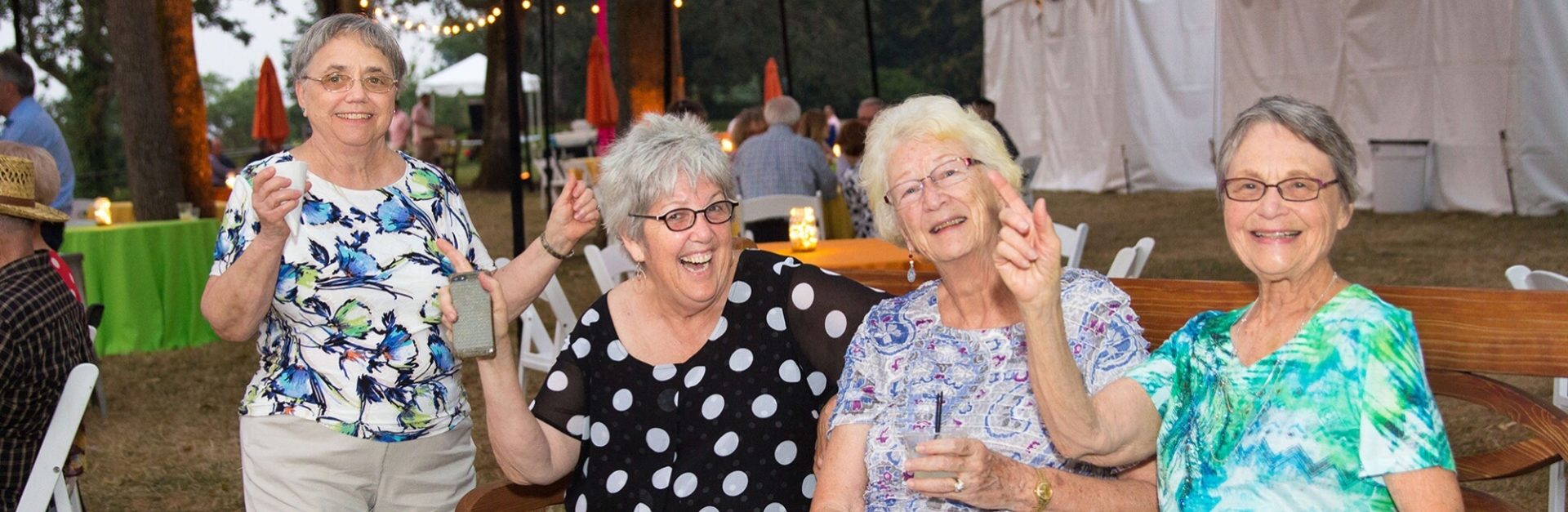 Four great women friends looking at camera and smiling