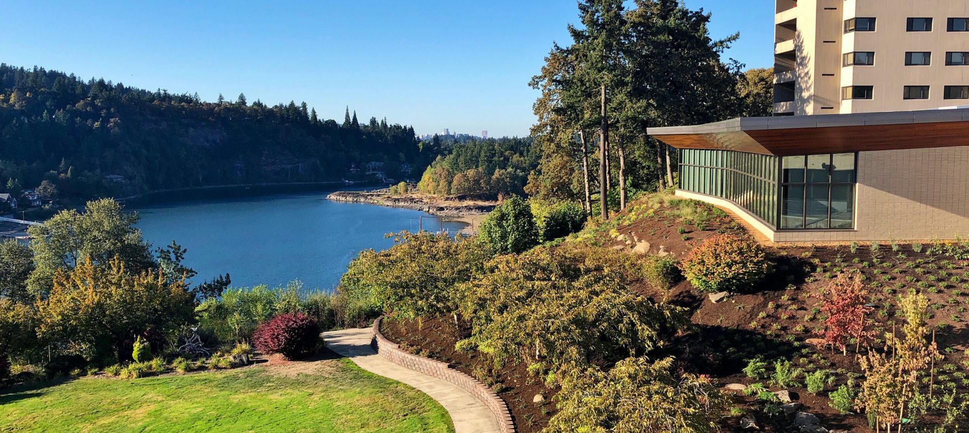 Lush landscaping and the Riverview dining room look out onto the Willamette River