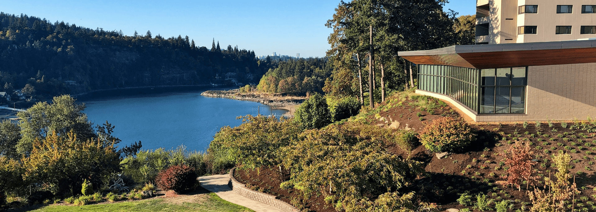 A view of landscaping and the Riverview dining area next to the Willamette River