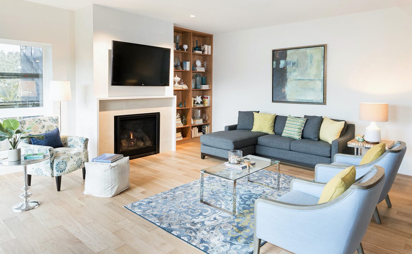 A Balcony Home living room with a modern fireplace at the center