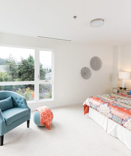 A large bedroom with lots of natural light in a Balcony Home