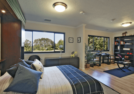 Bedroom with large windows in a Manor or Court apartment