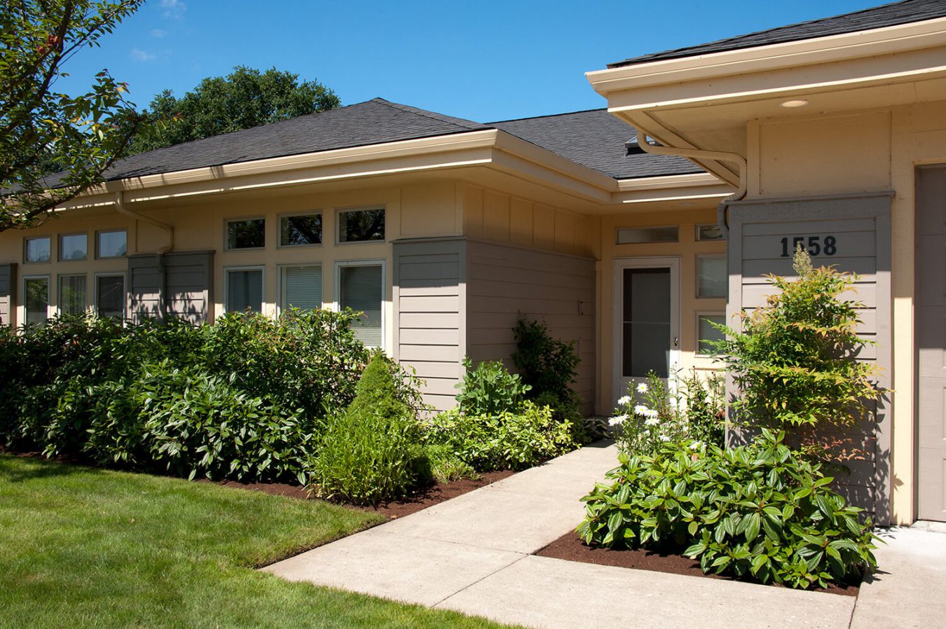 Exterior of a River Ridge Home with shrubs and flowers