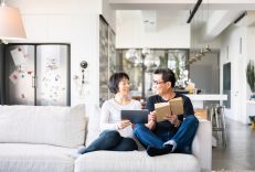 Couple taking to each other on their couch