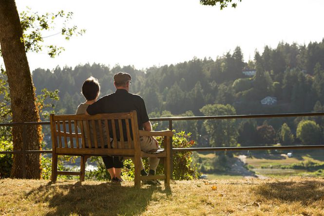 A couple on a bench enjoying nature at Willamette View