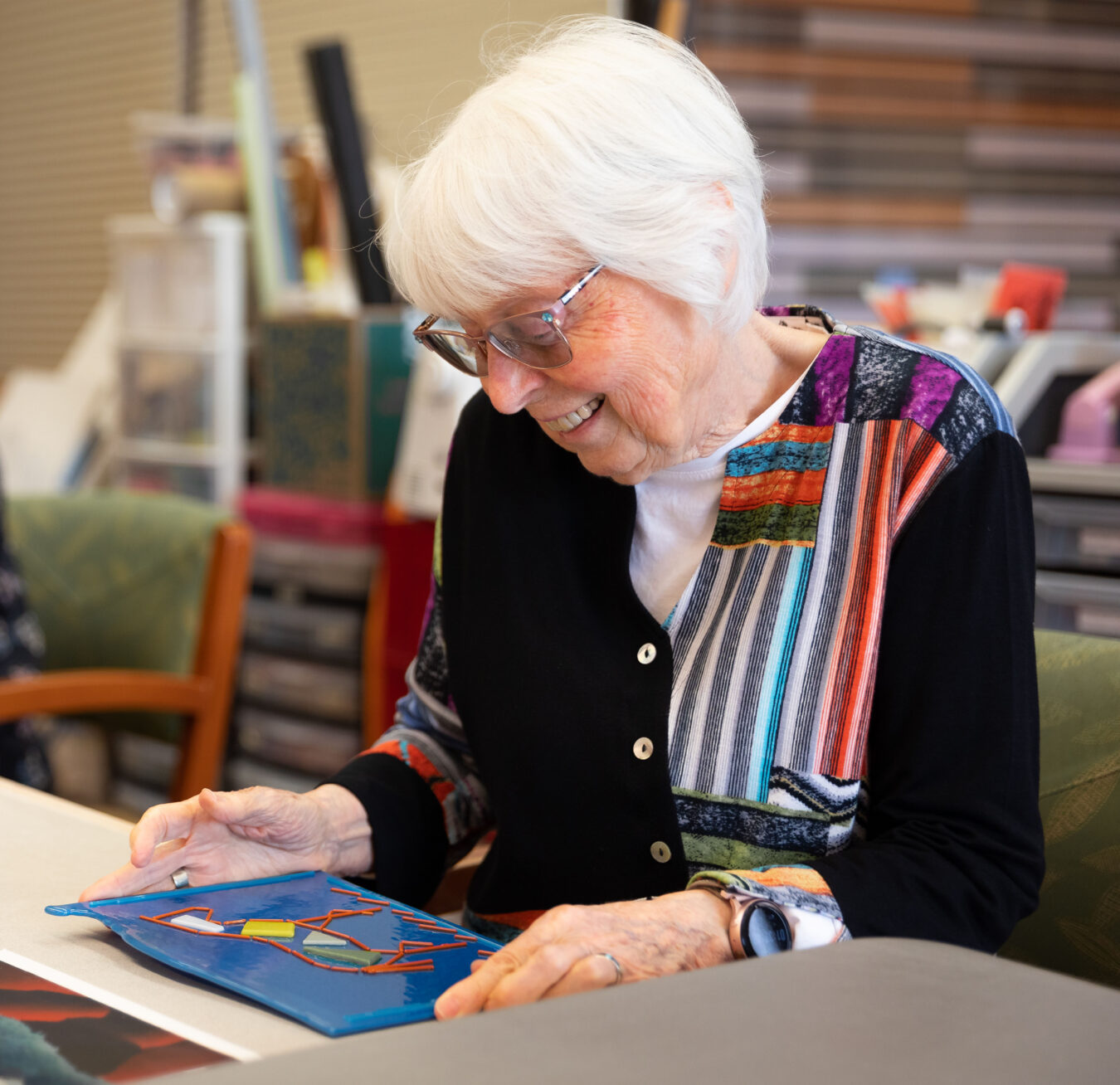 Woman looking at her artwork in an art studio.